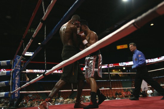 Referee Pete Podgorski circles as Granados (right) tries to penetrate Titsworth's defensive shell.