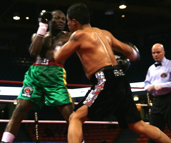 Hernandez (right) launches a right hook as referee Celestino Ruiz looks on.