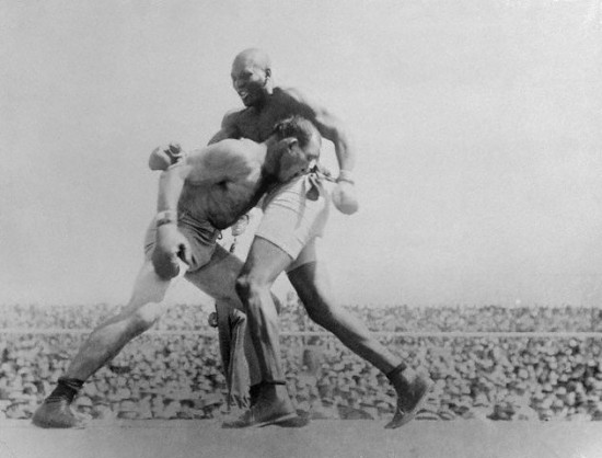 An aged Jim Jeffries (left) is overwhelmed by Jack Johnson