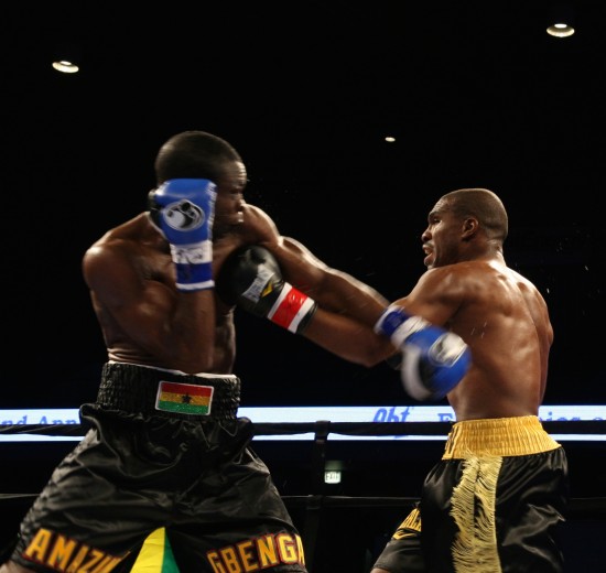 Gbenga, at left, and Williams exchange punches at rings center.